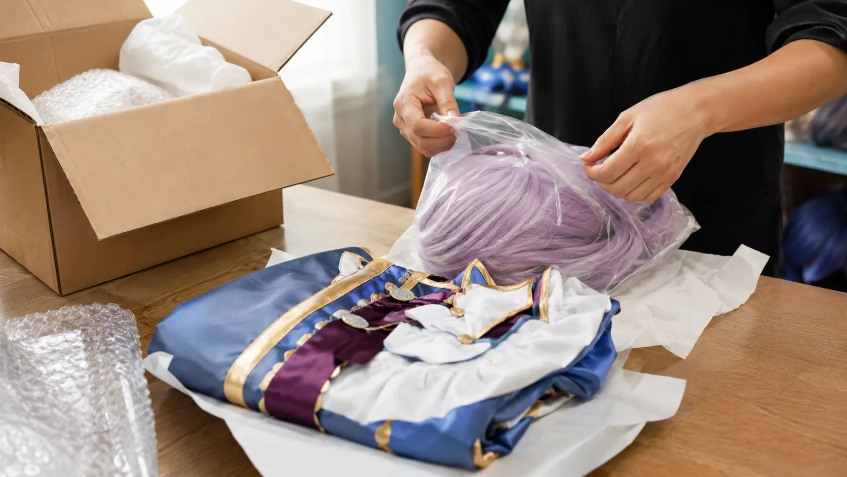Cosplay wig and folded costume being checked and packed carefully for overseas shipping